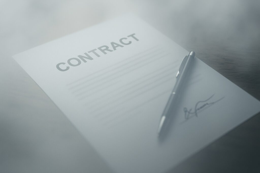 A foggy contract document on a desk with a pen resting on top, symbolizing negotiation uncertainty and decision fatigue.